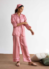 A woman in Pink Polka silk pajama set – polka dot women’s sleepwear by LaRosa